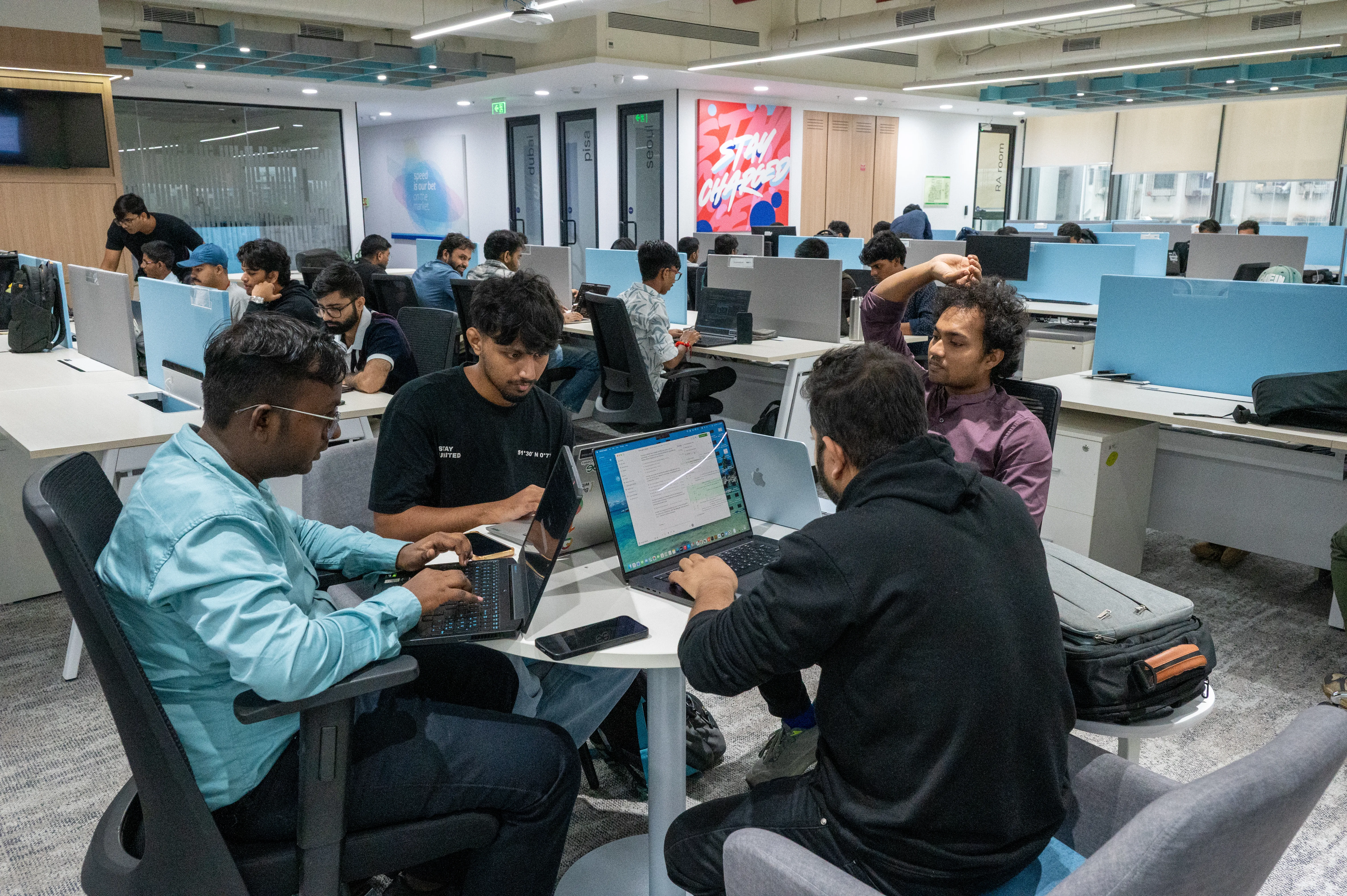 Attendees collaborating on laptops during a workshop at Dev Days Mumbai