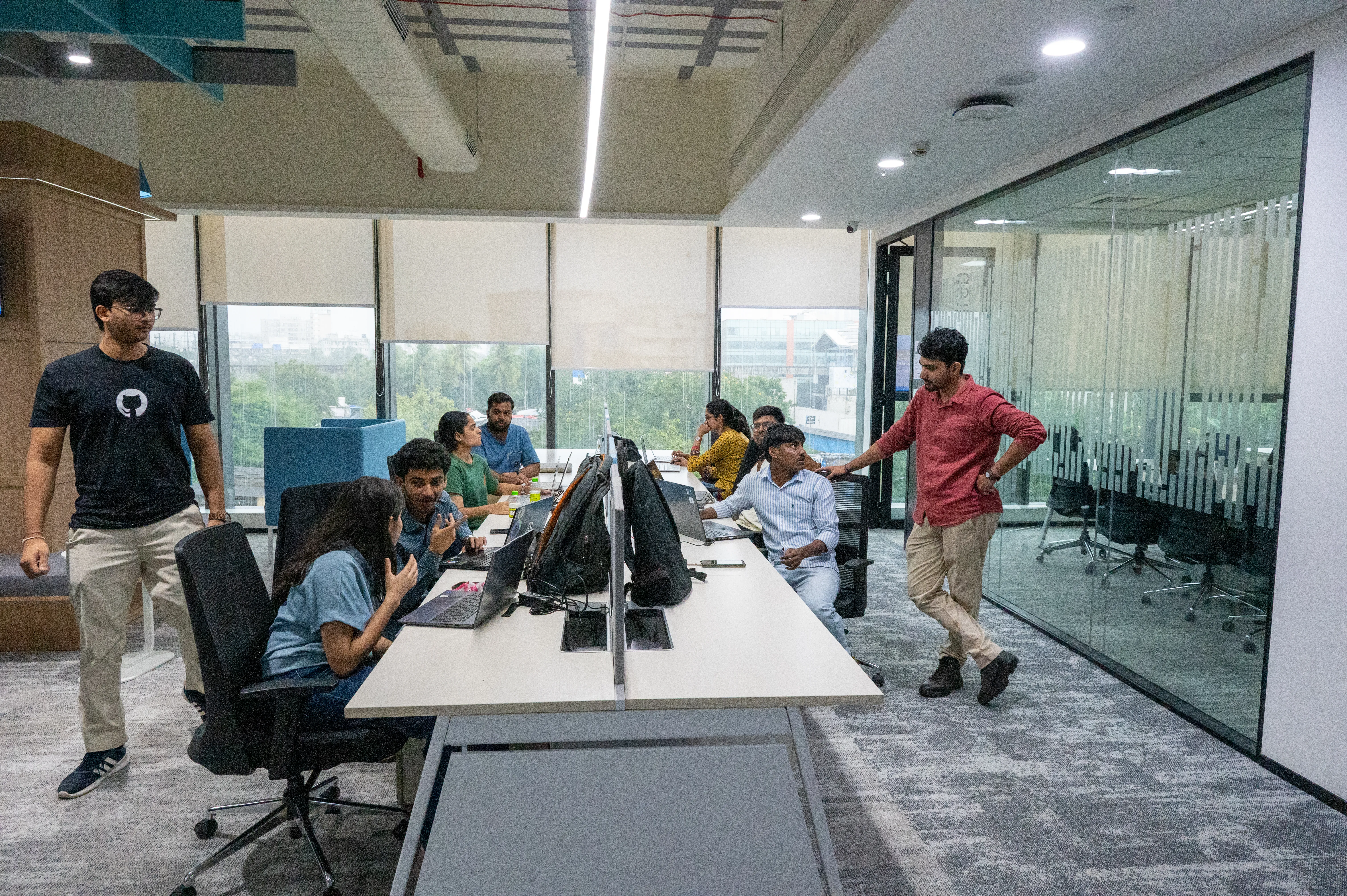 Paired developers at tables with a mentor helping attendees during a workshop at Dev Days Mumbai