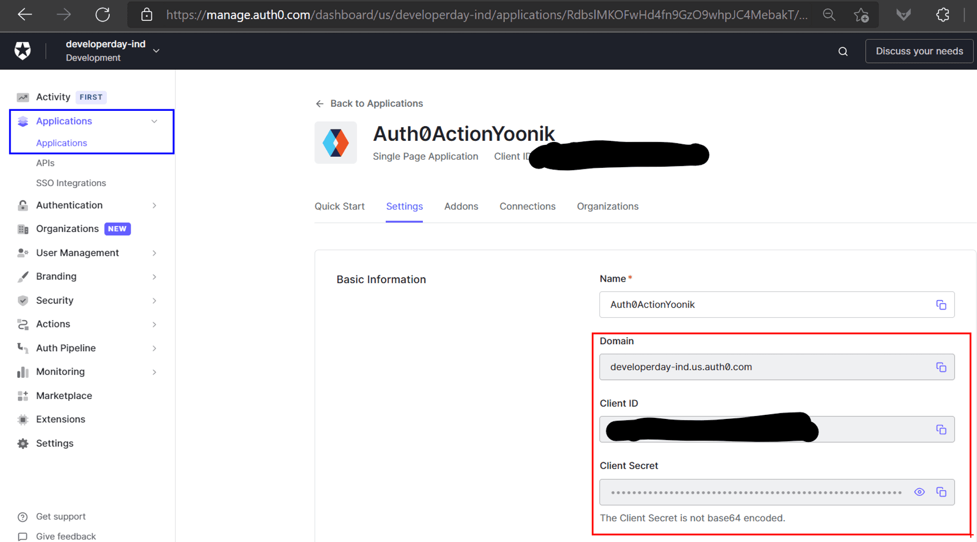 The Auth0 Application Details page with the Client ID and Client Secret information redacted